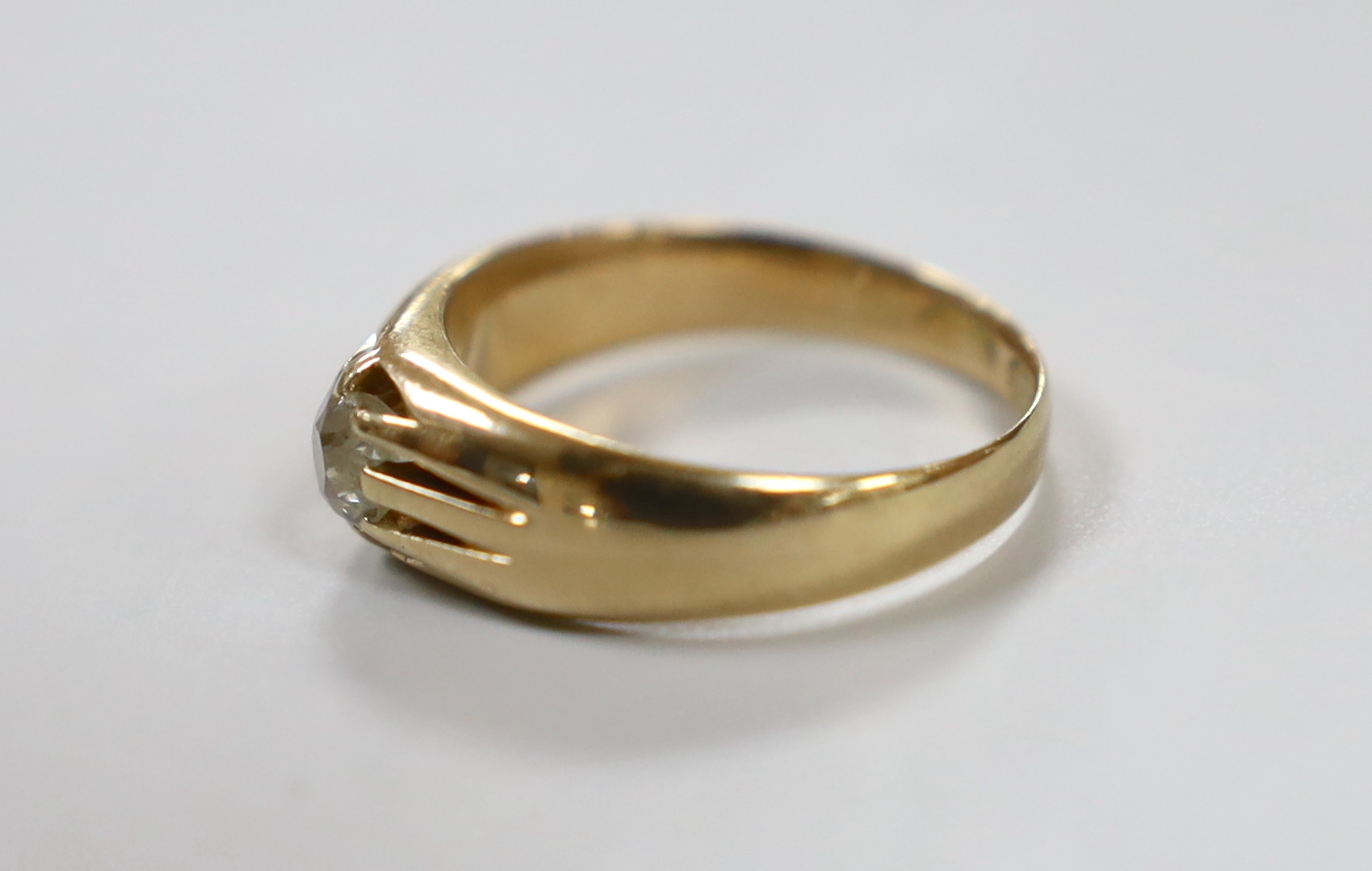 A late Victorian 15ct gold and claw set solitaire diamond ring, size Q, gross weight 5.5 grams.
